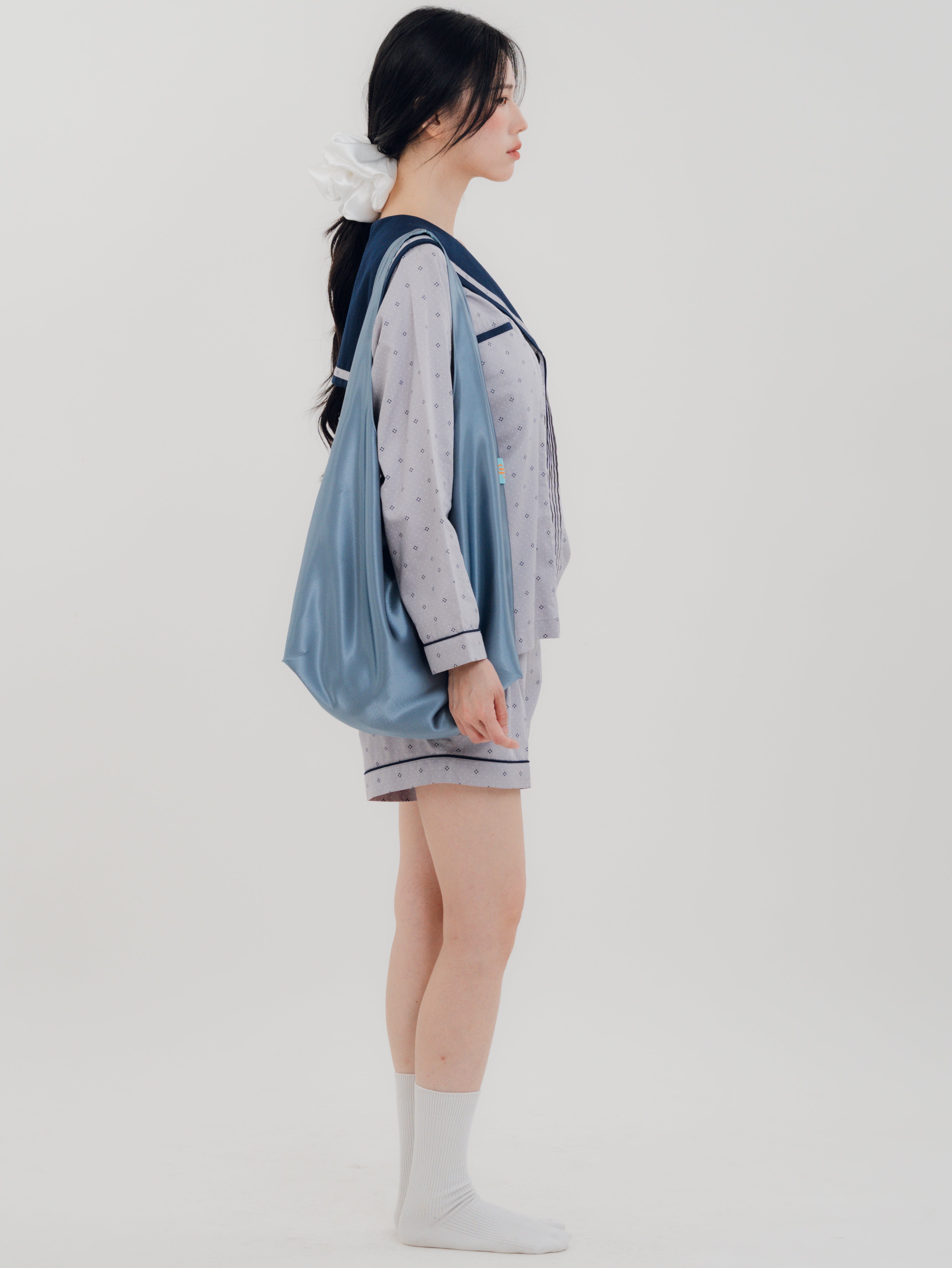 Woman side carrying the PEKGEE FairyTale Tote Bag as an elegant everyday bag.
