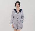Front view Woman wearing PEKGEE Sailorette Twilight Calm handmade premium cotton pyjama set.
