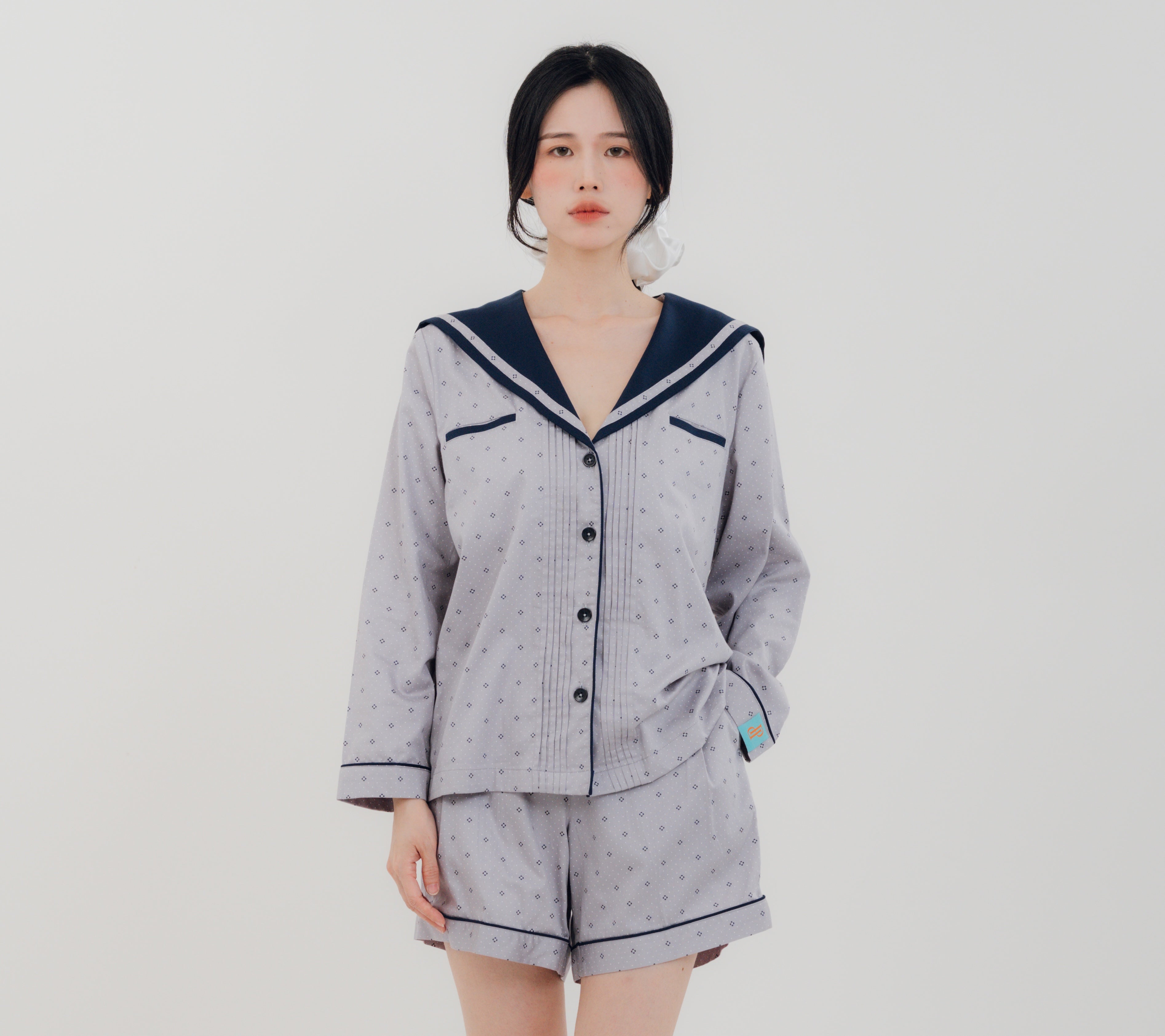 Front view Woman wearing PEKGEE Sailorette Twilight Calm handmade premium cotton pyjama set.